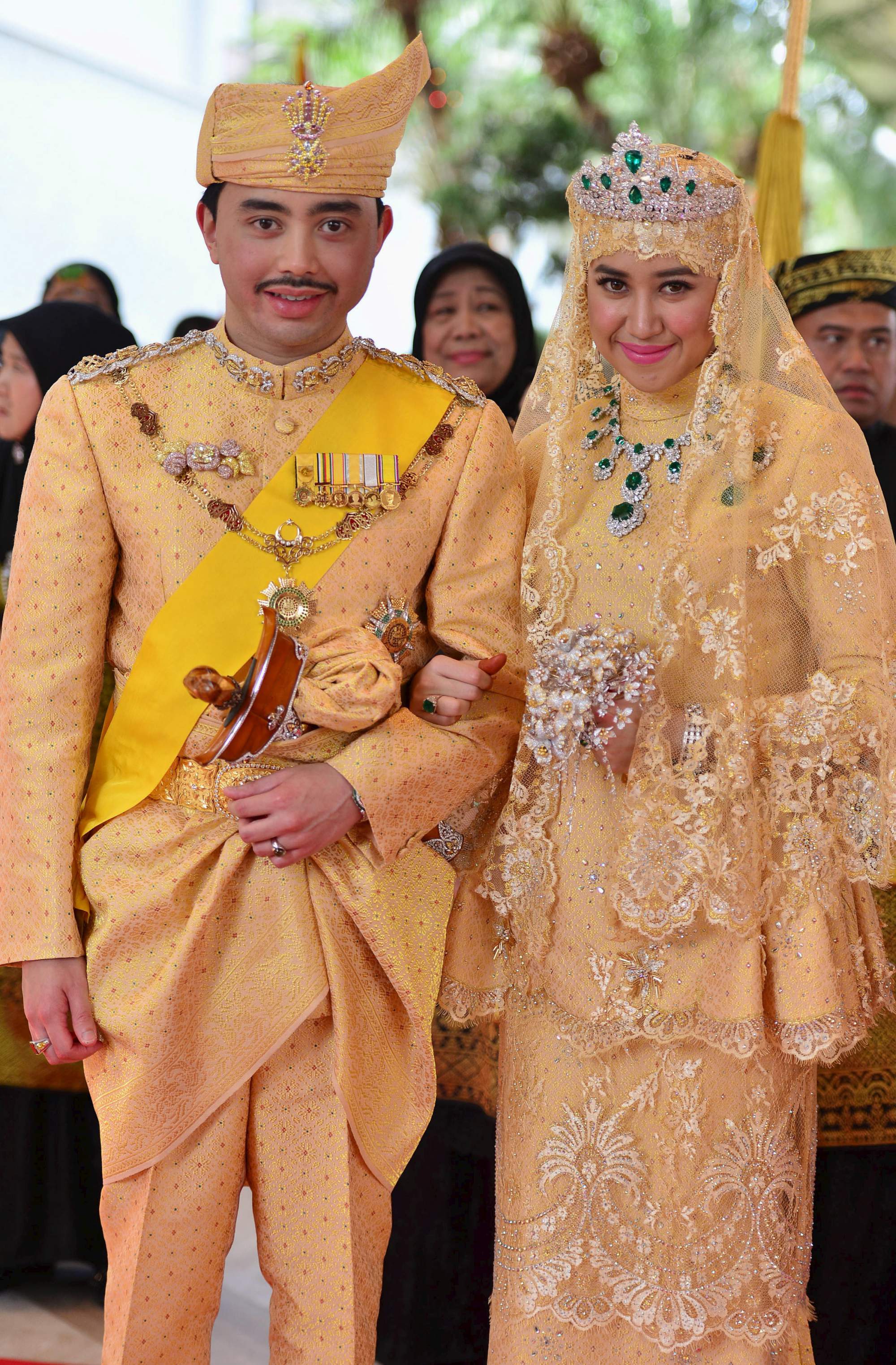 Brunei's newly wed royal couple, Prince Abdul Malik and Dayangku Raabi'atul 'Adawiyyah Pengiran Haji Bolkiah, pose for photographers after the enthronement ceremony at their wedding in the Nurul Iman Palace in Bandar Seri Begawan