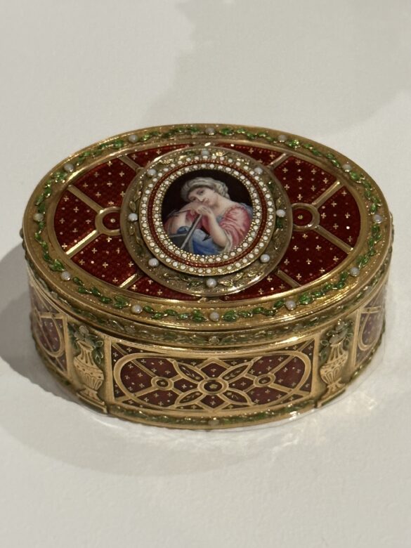 Snuffbox presented to Queen Mary by Mozelle Sassoon, Christmas 1934. Paris, c. 1762–68. Sablé gold with pearls, opals, and enamel; ¼ × 2 ½ × 1 13/16 in. (3.1 × 6.2 × 4.5 cm). Lent by His Majesty King Charles III. Photo Credit: Royal Collection Trust/© His Majesty King Charles III 2023