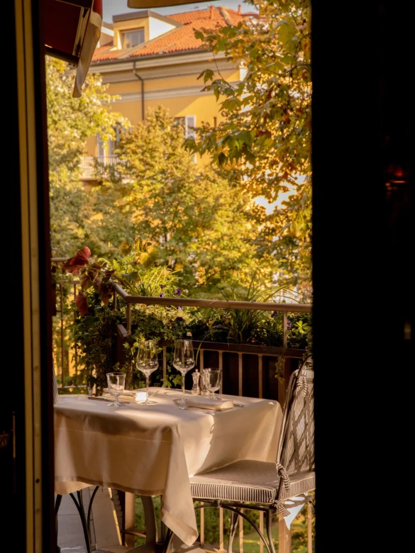 An outdoor dining setup at The Wilde, surrounded by greenery and soft evening light. Courtesy of The Wilde."