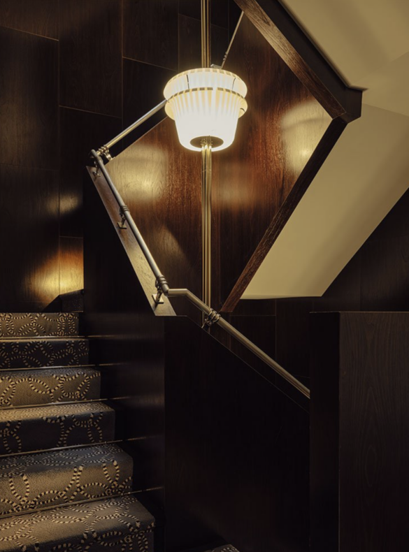 A grand staircase at The Wilde, illuminated by soft lighting and artistic details. Courtesy of The Wilde."