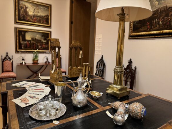 A collection of hand-painted plates displayed on a wooden dining table.