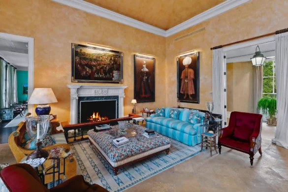 A richly decorated living room with ornate rugs and contemporary furniture.