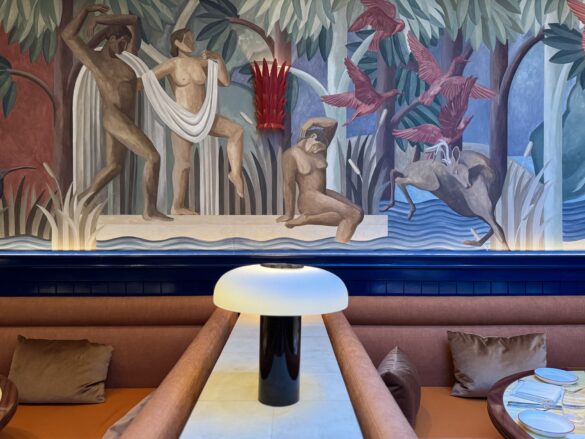 Restaurant booth seating with art deco inspired murals